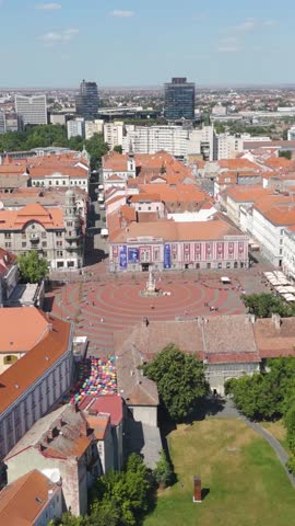 Vertical aerial drone panning across Liberty Square in the historic center of Timisoara, Romania.