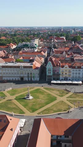Drone orbit showcasing Union Square in the heart of Timișoara, Romania, with surrounding buildings and streets.