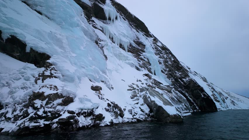 Icy cliffs and dark Arctic Ocean by southwestern coast of Greenland