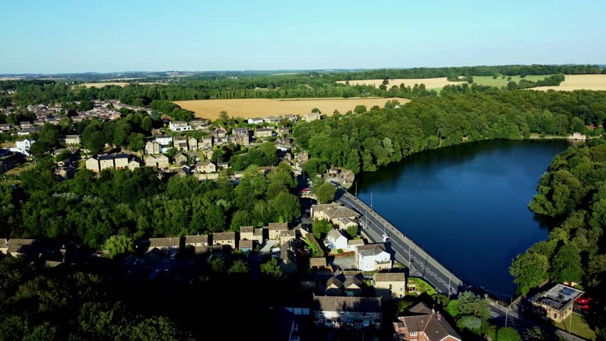 Aerial approach over road into Newmillerdam wildlife reserve and lake