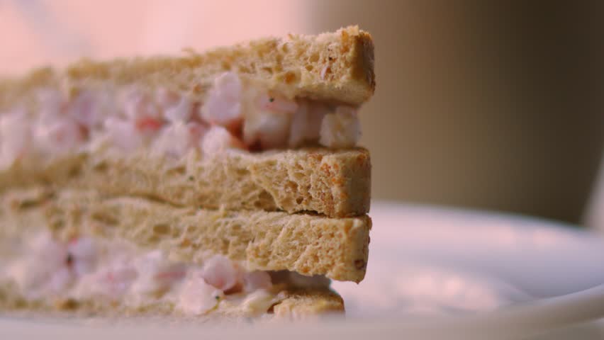 Panning View of Appetizing Delicious Prawn Sandwich Stacked on White Plate Ready to Eat for Lunch or Snack. Seafood with Marie Rose Sauce Between Slices of Bread.