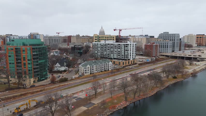 Drone perspective over Madison’s downtown skyline in winter, with the Wisconsin State Capitol standing out beneath overcast skies.