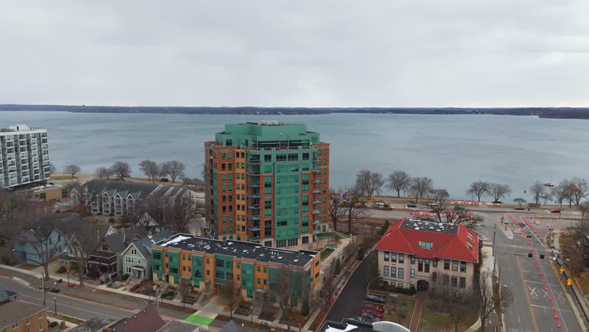 Winter aerial of Madison, WI showing urban architecture, muted tones under a blanket of clouds.