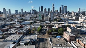 Aerial drone footage flying toward downtown Los Angeles buildings, capturing city architecture, busy streets, moving cars, and urban life in daylight with a modern metropolitan skyline. - Powered by Shutterstock - Get 15% off with code: PIKWIZARD15