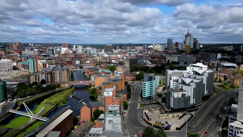 Aerial footage flying along the A61 towards the Leeds city centre, with roads, traffic and nearby River Aire illustrating transport links, commuter travel and everyday connectivity in a major UK city.