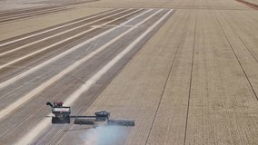 Combine harvester offloads grain into tractor trailer while moving through wheat paddock - Powered by Shutterstock - Get 15% off with code: PIKWIZARD15