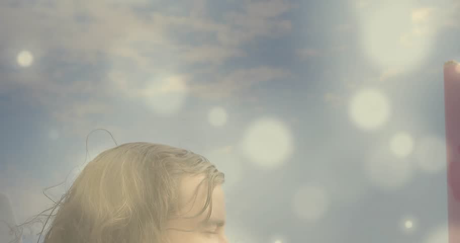 couple hugging at seaside woman leaning into backlit man sparking drifting light orbs for marketing. Romance, intimacy, serenity, dusk, silhouette, connection, tranquility