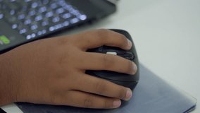 Close-up of a student s hand holding a computer mouse during a STEM programming or robotics class, working on coding or electronics project. - Powered by Shutterstock - Get 15% off with code: PIKWIZARD15