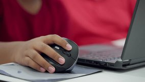 Close-up of student s hand on a wireless computer mouse, working on a laptop during a STEM coding session or online learning activity. - Powered by Shutterstock - Get 15% off with code: PIKWIZARD15
