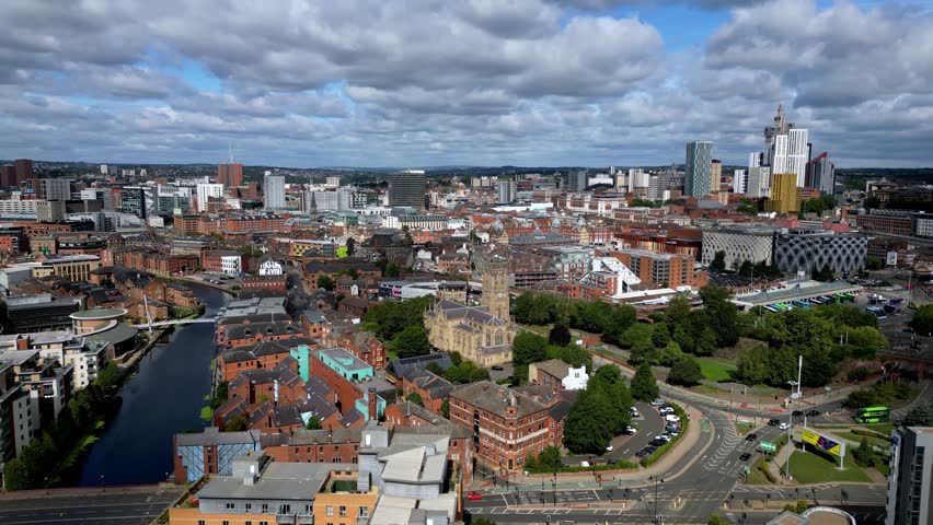 Aerial drone footage towards Leeds Minster, showcasing Gothic Revival architecture, with the Leeds city centre skyline beyond in a major UK cityscape. Anglican Church within Diocese of Leeds