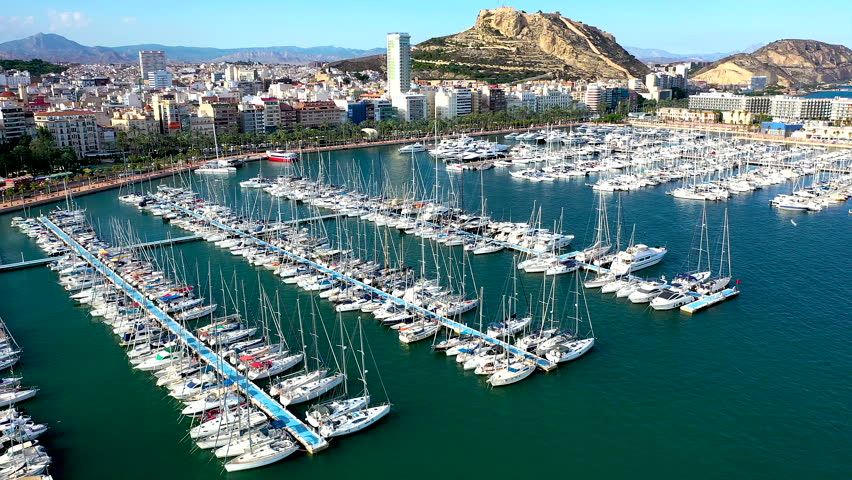 Aerial view of the Marinas inside the port of Alicante, the beach of El Postiguet and Santa Barbara Fortress in the Mediterranean city of Alicante, Spain.