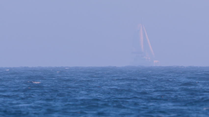 A tranquil sailboat journey through the misty sea near Orłowo captured in high definition.