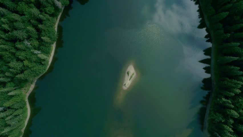 Small island in the middle of lake, small island isolated in middle of serene lake. pristine minimalistic oasis creating focus and retreat themes