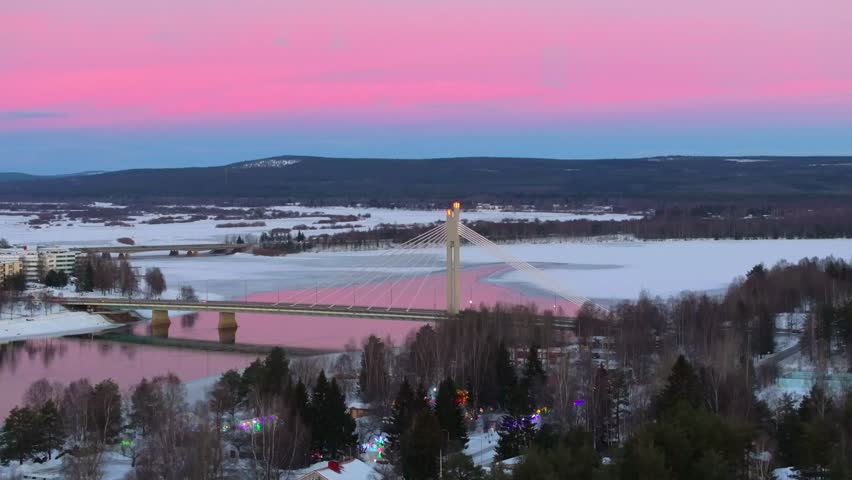 4K cinematic drone footage of Rovaniemi, Finland, captured at golden hour during the winter solstice, showcasing the iconic Jätkänkynttilä (Lumberjack’s Candle) Bridge_27