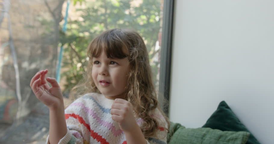 Female Sisters Blowing Bubbles in Living Room