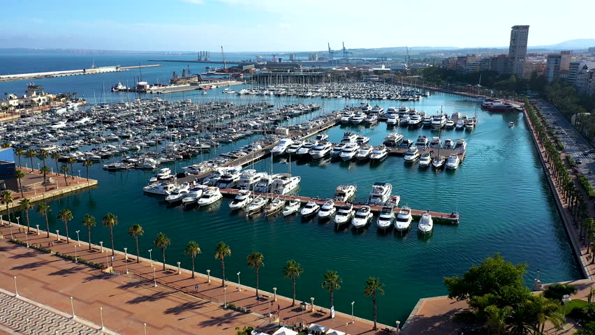 Aerial view of the Marinas inside the port of Alicante, the beach of El Postiguet and Santa Barbara Fortress in the Mediterranean city of Alicante, Spain.