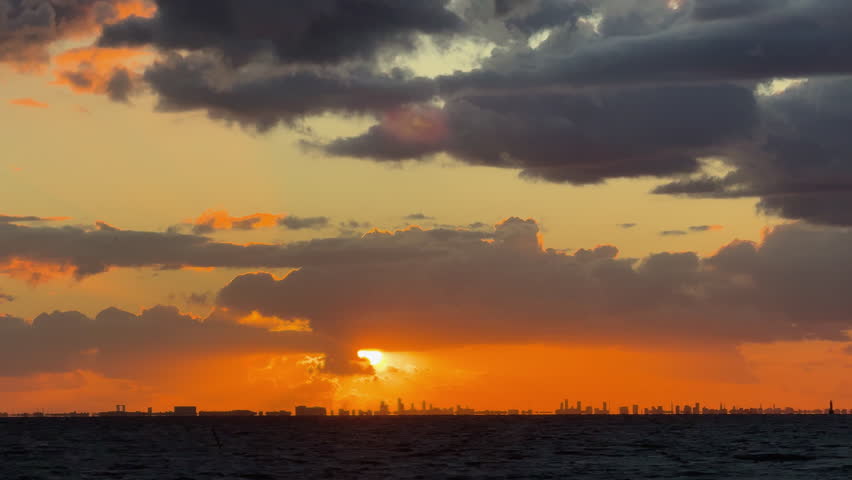 Dramatic orange sunset over Copenhagen skyline and ocean