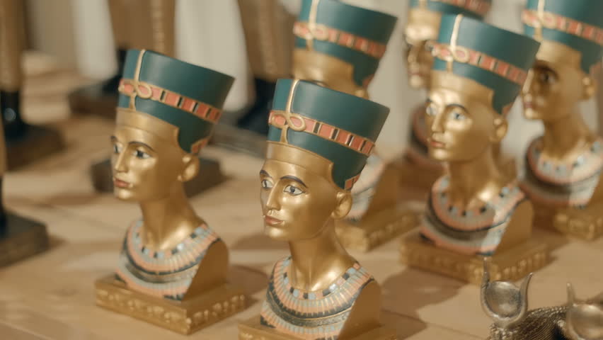 The souvenir shop sells metal busts of Goddes Nefertiti, the symbol of Ancient Egypt. Closeup. Shot in motion