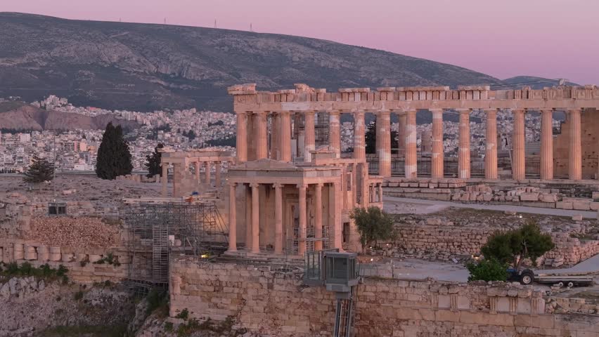 Lateral drone shot using a telephoto lens revealing the Parthenon in Athens, highlighting ancient architecture with smooth cinematic motion and strong depth compression.