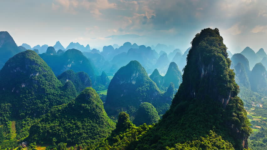 Aerial shot of spectacular karst mountain peak and green valley natural landscape in Guilin, China. 