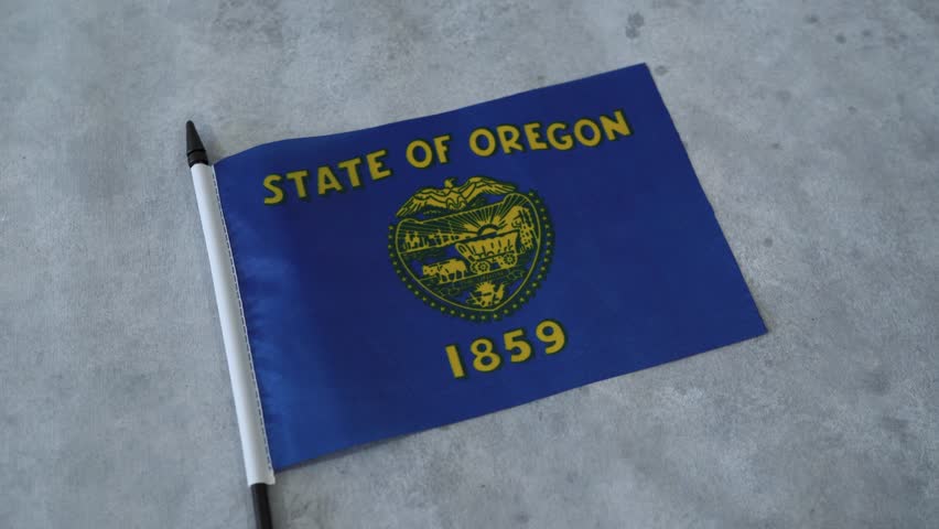 Oregon state flag close up on grey background. US American state flags. Orbiting Zoom in shot.