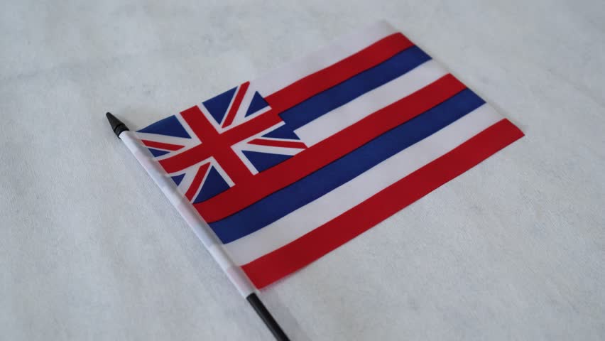 Hawaii state flag close up on white background. US American state flags. Orbiting shot.