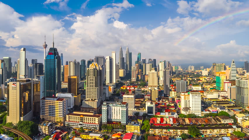 Time lapse of Beautiful and dramatic sunset with rainbow of the KL skyline overlooking the national landmarks,  the Petronas Twin Towers. 