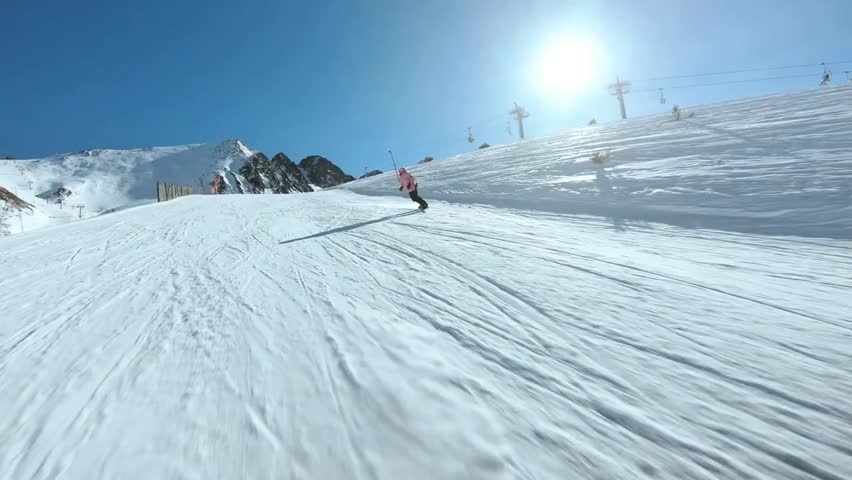 “Young woman snowboards on a pristine piste at a ski resort, embracing an active lifestyle, winter adventure, and thrill of mountain sports.”