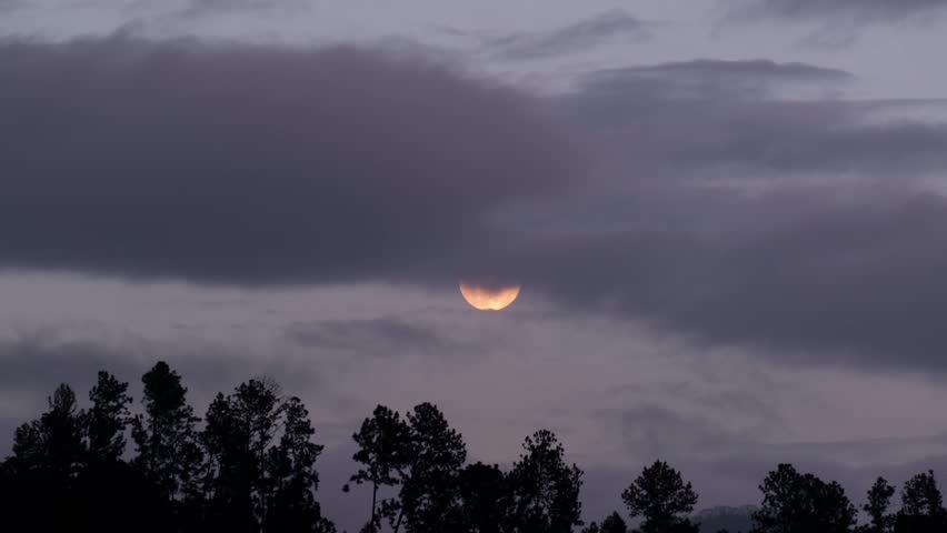 Full moon over the mountains in Sri Lanka, View of the full moon on a cloudy evening from a hotel room in Ella.