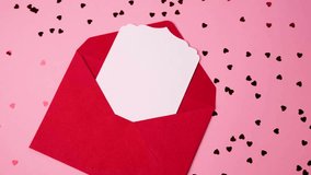 Open vibrant red envelope with blank white card surrounded by heart confetti for Valentine's Day - Powered by Shutterstock - Get 15% off with code: PIKWIZARD15