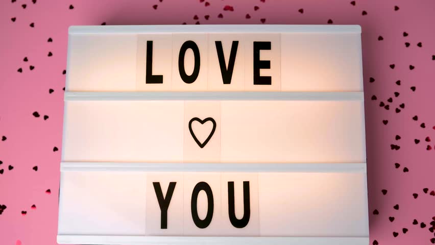 Light box displaying "Love You" message with hearts on a pink background for Valentine