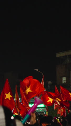 Vietnamese soccer fans celebrating victory at night