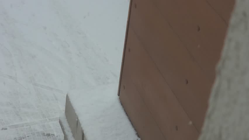Snow Beautifully Falling In The Corner Of A Building And View Of The Street
