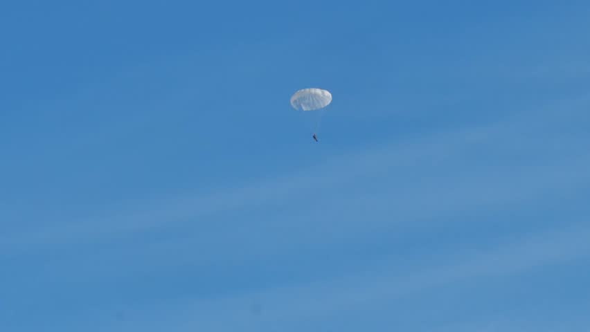 Parachutists land on the runway of an airfield. Parachute jump.
