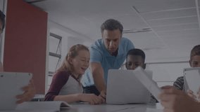 Mathematical equations against caucasian male teacher using laptop and teaching kids at school. School and education concept - Powered by Shutterstock - Get 15% off with code: PIKWIZARD15