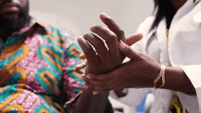 Female African Doctor Performing Physical Examination of Male Patient Hand in Hospital - Powered by Shutterstock - Get 15% off with code: PIKWIZARD15