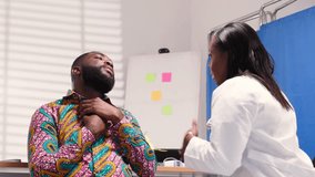 African female doctor provides comfort and care to a male patient experiencing chest pain or discomfort in hospital - Powered by Shutterstock - Get 15% off with code: PIKWIZARD15