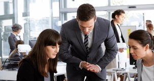 Colleagues leaning over desk examining documents initiating world map overlay for business analysis. Collaboration, analytics, innovation, digital, teamwork, strategy, technology - Powered by Shutterstock - Get 15% off with code: PIKWIZARD15