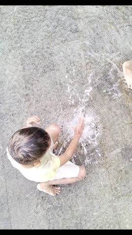 From above, you can see small children playing in the fountain park and experimenting with putting plastic bottles on top of the fountain, an exciting moment.