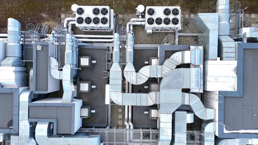 Aerial view of industrial rooftop showcasing extensive HVAC system with interconnected ducts, vents, and units demonstrating complex engineering and design in a modern facility layout