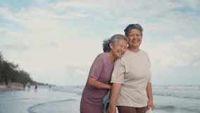 Asian mature LGBTQ couple walking together on a sunny beach by the sea during a romantic vacation - Powered by Shutterstock - Get 15% off with code: PIKWIZARD15