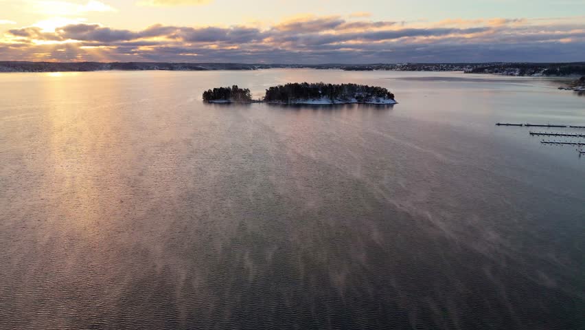 Beautiful sunrise over an island in the archipelago of Stockholm, Sweden, after a snowstorm