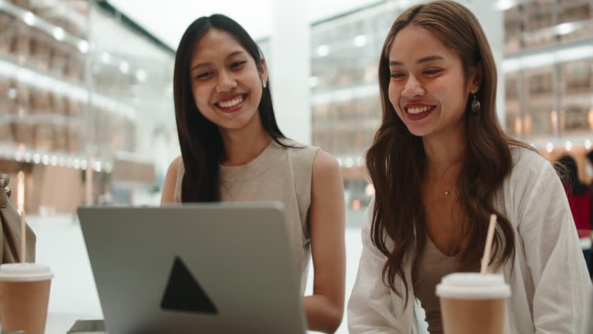 Asian girlfriends enjoying coffee and video chat