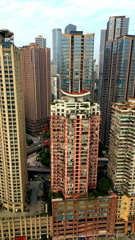 Aerial view of multiple skyscrapers with contrasting colors and textures in a densely populated area of the city, Chongqing, Chongqing, China.