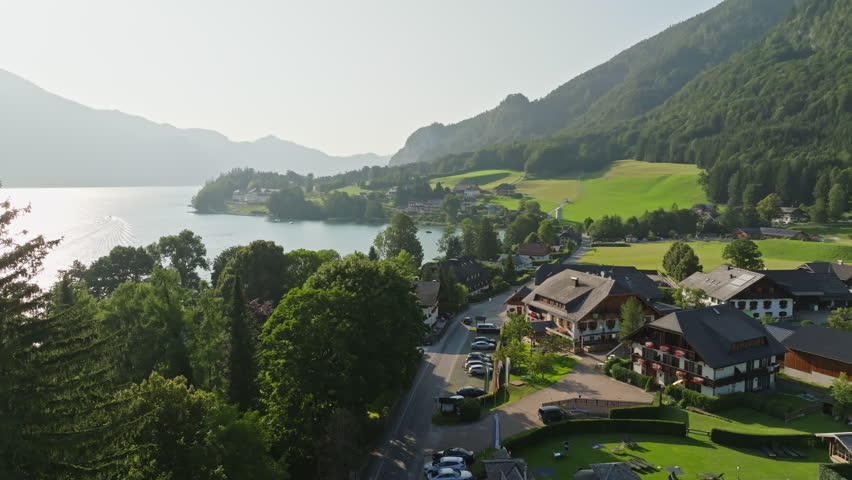 Aerial view of Lake Wolfgangsee in Austria featuring alpine mountains calm water and stunning natural scenery in a famous European travel destination