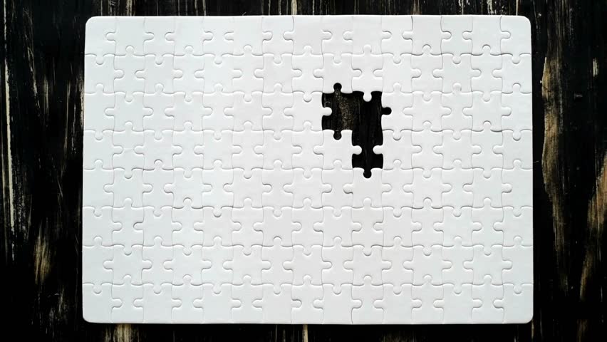 Light puzzle putting the jigsaw puzzle filling by hand chroma key Board game in bright colors. Hand putting last piece of puzzle