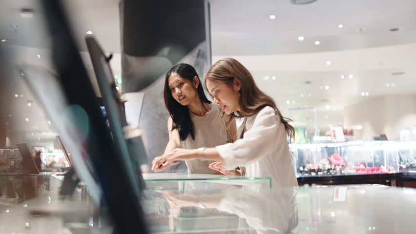 Young asian women choosing jewelry in a store