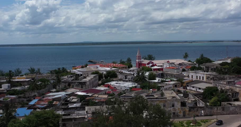Aerial view of the beach meeting the town