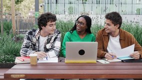 Black female student with classmates using laptop working and learning together discussing about project - Powered by Shutterstock - Get 15% off with code: PIKWIZARD15
