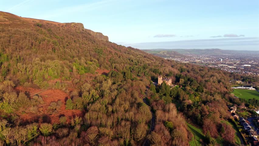 Wide advancing 60FPS 4K aerial video of Belfast Castle and Cave Hill in North Belfast, Northern Ireland on a bright autumn day. Produced with Rec709 color.